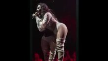 Demi Lovato bending over on stage