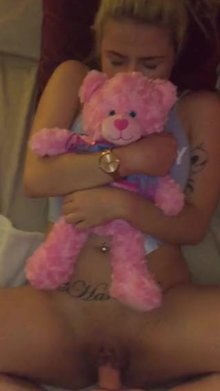 holding her teddy bear close by while she takes a thick cock