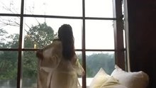 Woman gets naked in front of window