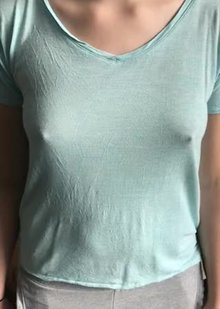 Bouncing her small tits around under her shirt